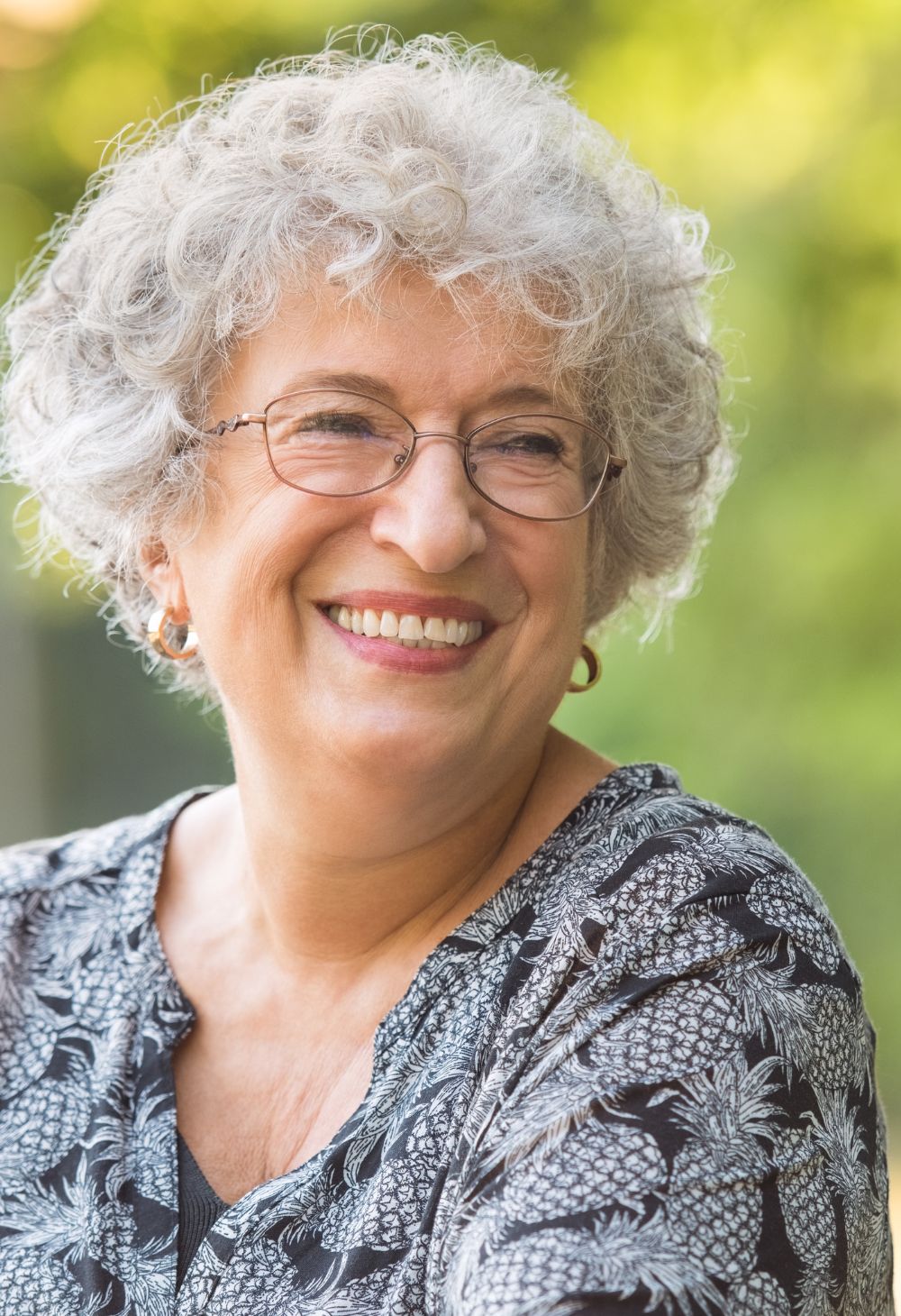 Smiling elderly woman enjoying a bright moment at home, feeling cared for and comfortable.